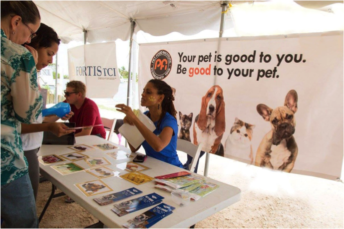  Not Safe! Game - Pet Food Institute participated in the TCSPCA Dog Show November 12 at Turtle Cove Marina, debuting a new game designed to raise awareness about foods that are dangerous to dogs and cats. “What TCSPCA has done for raising the standards of pet care in such a short time is incredible,” said Sandra Kemp, PFI representative (seated). “Pet Food Institute is really happy to support their largest annual fundraiser.”